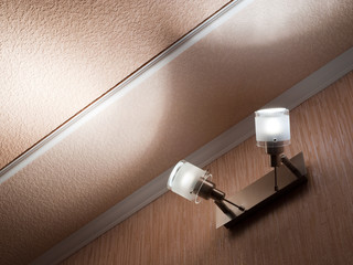 Two modern ceiling lights mounted on a wall