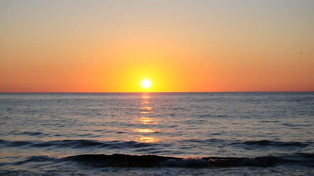 Sunrise over the sea slowly blurring