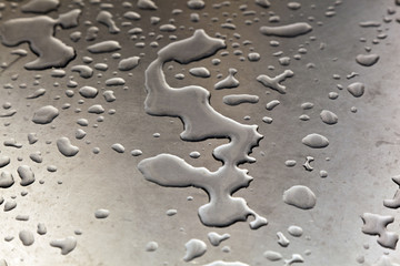 water on silver metal table in harmonic form