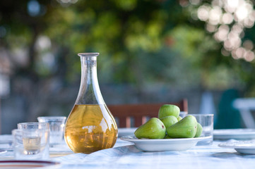 table setting with white wine and fresh figs outside