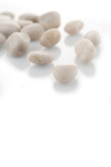 Fototapeta na wymiar White stones on white background focused