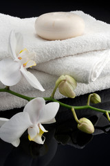 Obraz na płótnie Canvas round soap on square white towels, black bacground