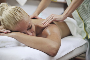 Fototapeta na wymiar woman at spa and wellness back massage