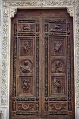 Fototapeta na wymiar Carved Wooden Door Basilica Santa Croce Cathedral Florence Italy