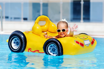cute toddler girl have a fun in pool outdoor