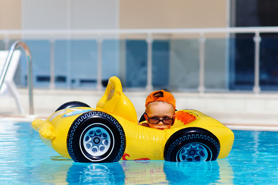 cute toddler boy have a fun in pool outdoor