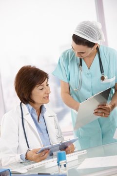 Nurse and senior doctor analysing diagnosis