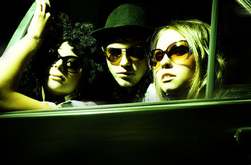 Happy young friends in the car