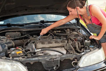 Woman with her broken down car