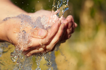 Fototapeta premium Woman's hands with water splash
