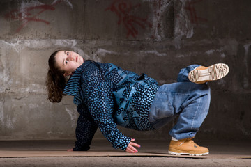 Hip hop dancer in modern style over brick wall