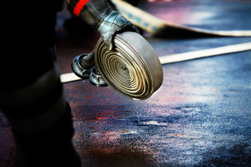 fire fighter grabbing a fire hose