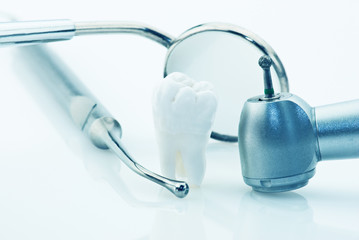 Real human wisdom tooth and dental tools.
