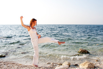 Woman walking barefoot on the beach