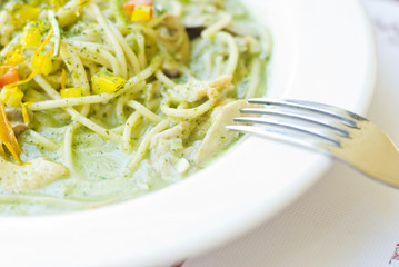 Delicious noddles in white dish with fork