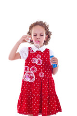 little girl blowing soap bubbles