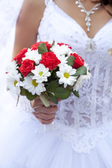 Bride holding beautiful red roses wedding flowers bouquet