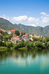 Fototapeta na wymiar Villa near the river with mountain in the background