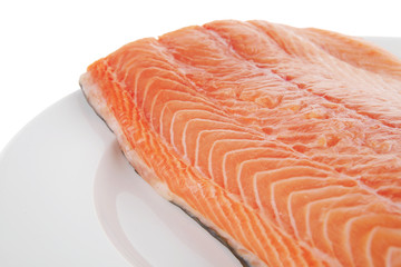 big salmon fillet on white plate