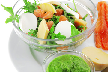 salad with salmon in transparent bowl
