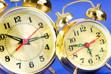 Time concept - alarm clock against colorful background
