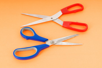 Colorful scissors on the color paper background