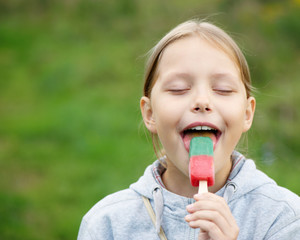 Cute little blond firl eating ice cream