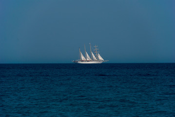 White ship on sea horizon