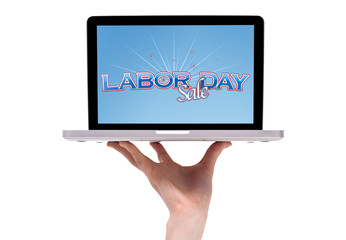 a male hand holding a laptop with a labor day sign