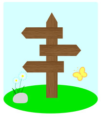 Wooden arrow standing on the grass