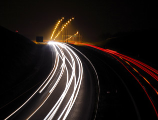 Highway with car lights trails at night