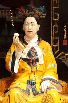 Famous woman emperor of China Cisi is eating dumpling
