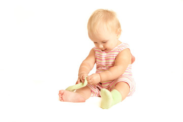 cute young baby play with own socks