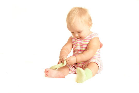 cute young baby play with own socks