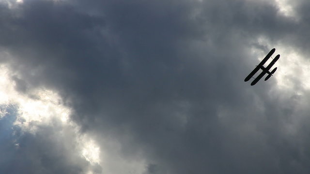 Airplane old biplane on dramatic sky