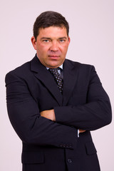 Portrait of a mature business man on a grey background