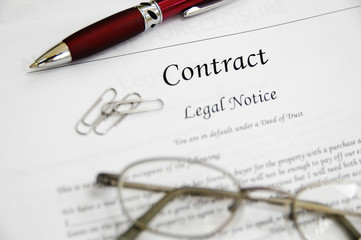 legal contract papers with pen and glasses