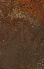rusty plate of metal with some leftover orange paint