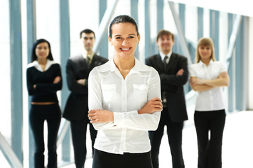 Obraz premium Five young business persons are standing as a team