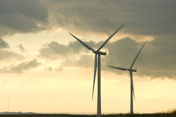 Fototapeta premium Two wind turbines at dusk