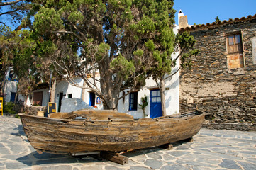 Old boat with a cypress in Portlligat, Cadaques, Spain