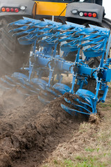 Tractor pulling plow