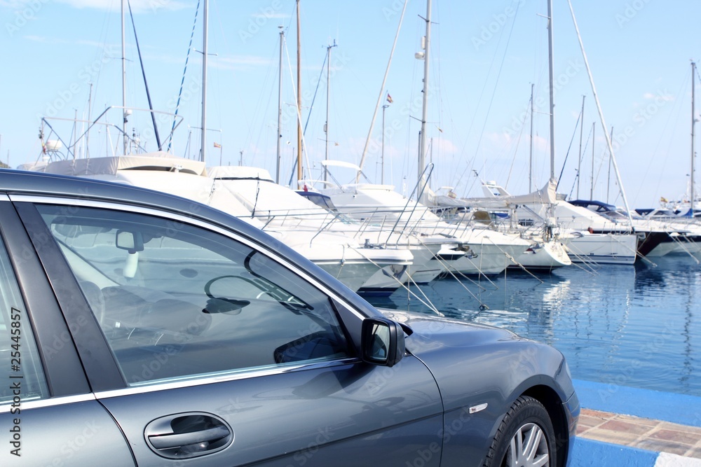 Sticker luxury car and yacht sailboats on Spain marina