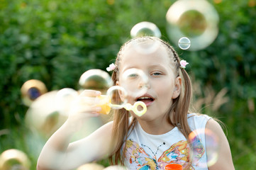 Cute Little Girl blowing bubbles