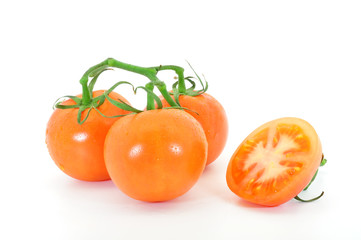 truss tomatoes and cut tomato isolated on white