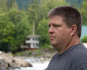 Serious ordinary guy outdoors