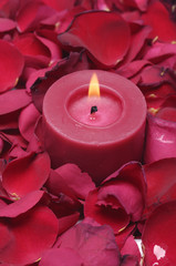 Close up candle with red rose petals
