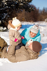 Family playing on snow