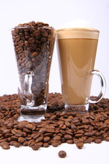 Caffe latte, glass of coffee beans surrounded by coffee beans