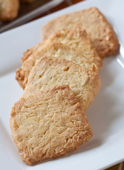 Pastry cakes with sugar on plate.